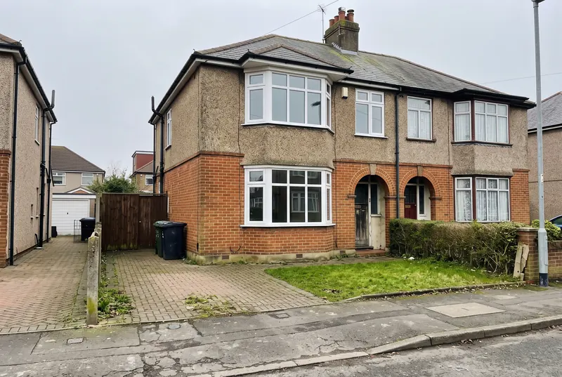 1930s semi-detached house with white uPVC double glazed bay windows